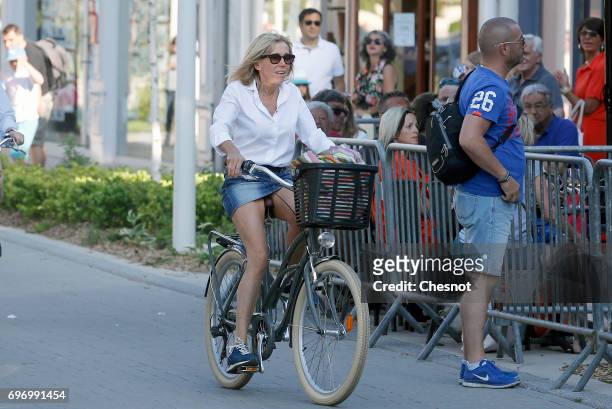 Wife of French President Emmanuel Macron, Brigitte Trogneux returns to her home on a bicycle the eve of the second round of the French parliamentary...