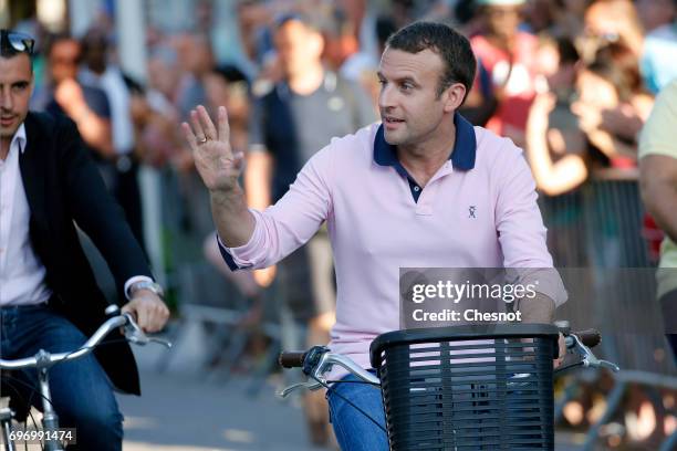 French President Emmanuel Macron leaves his house on a bicycle on the eve of the second round of the French parliamentary elections on June 17, 2017...