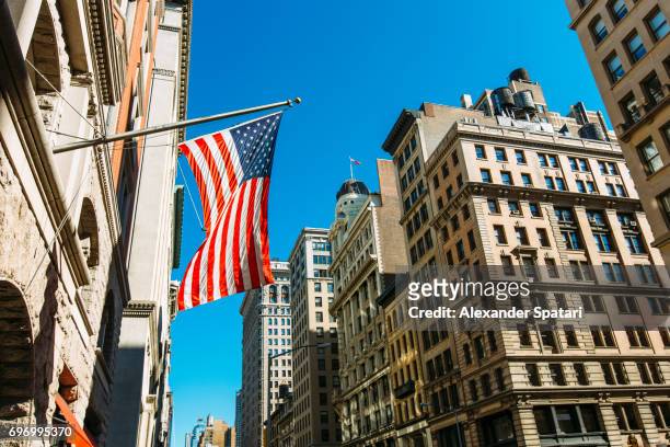 american flag on a building at fifth avenue, manhattan, new york city, united states - american flag jpg stock pictures, royalty-free photos & images