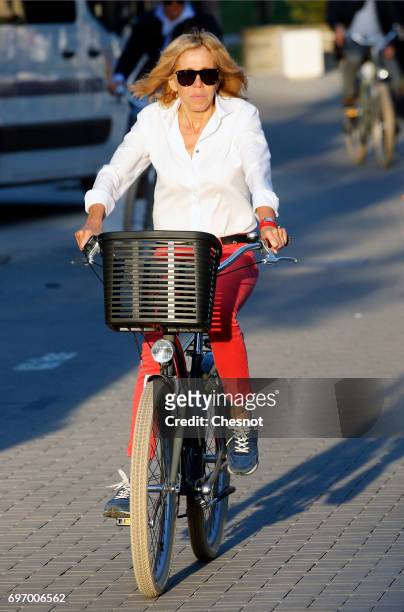 Wife of French President Emmanuel Macron, Brigitte Trogneux returns to her home on a bicycle the eve of the second round of the French parliamentary...