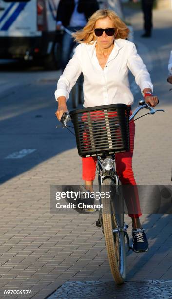 Wife of French President Emmanuel Macron, Brigitte Trogneux returns to her home on a bicycle the eve of the second round of the French parliamentary...