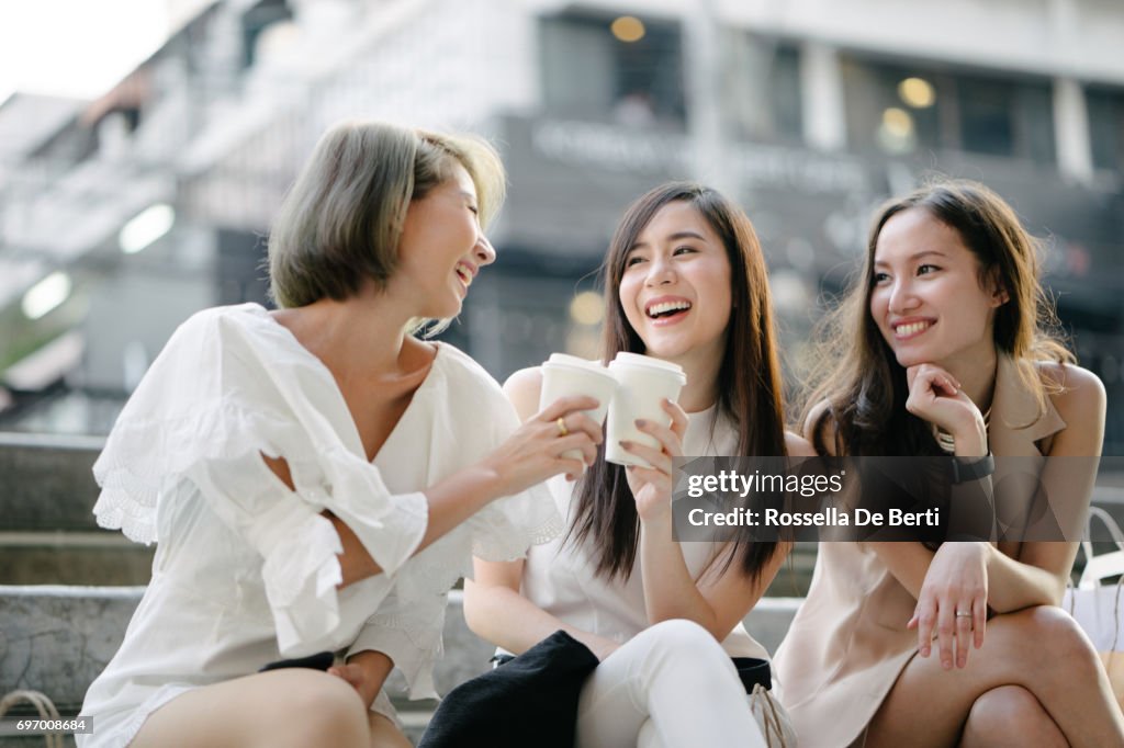 Women friends out for shopping in Bangkok city streets