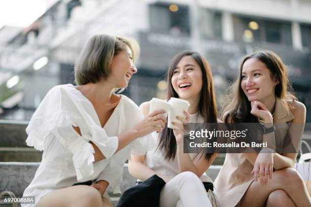 women friends out for shopping in bangkok city streets - asia stock pictures, royalty-free photos & images