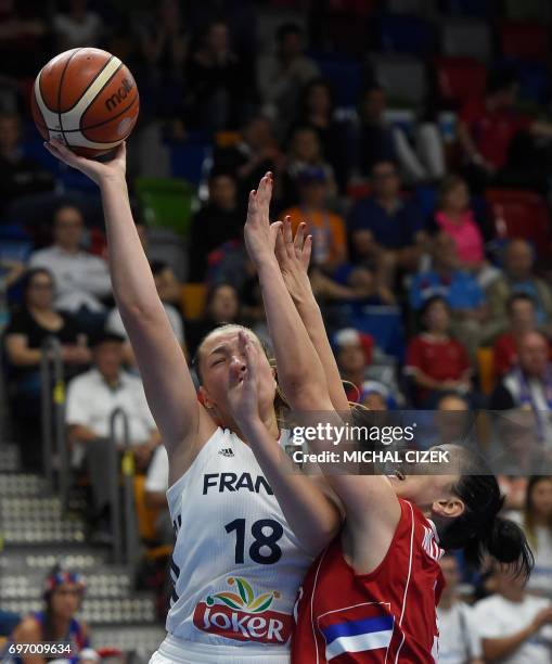 Jelena Milovanovic of Serbia trys to block France's Alexia Chartereau during the FIBA EuroBasket women's basketball match France v Serbia on June 17,...