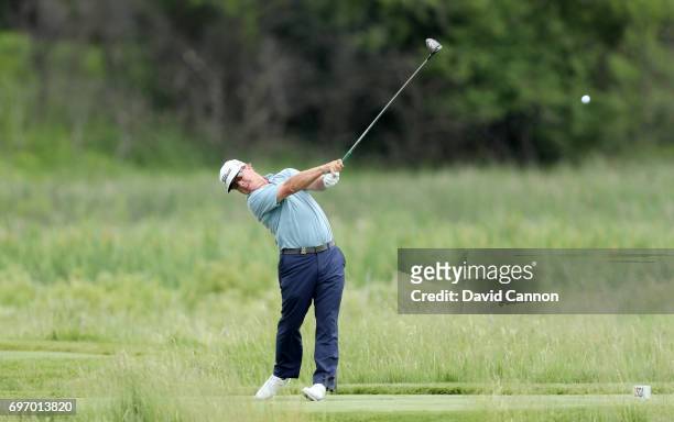 Charley Hoffman of the United States plays his tee shot at the par 4, second hole during the third round of the 117th US Open Championship at Erin...