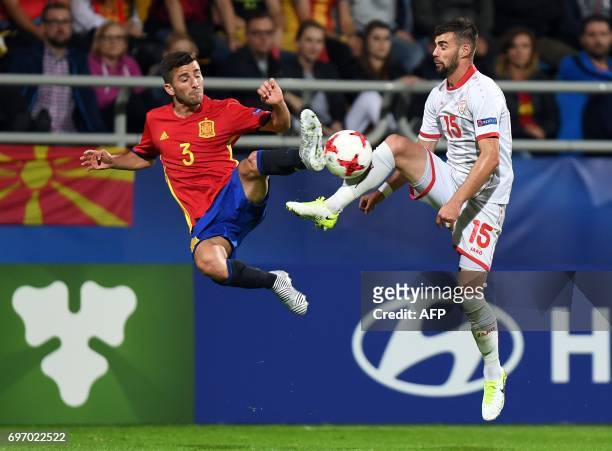 Spain's defender Jose Gaya and Macedonia's defender Egzon Bejtulai vie for the ball during the UEFA U-21 European Championship Group B football match...