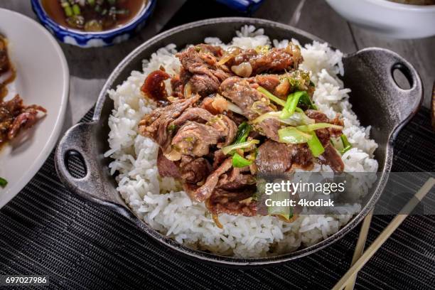 delicious bulgogi , marinated in soy sauce and garlic and ginger,over steamed rice - rice bowl stock pictures, royalty-free photos & images