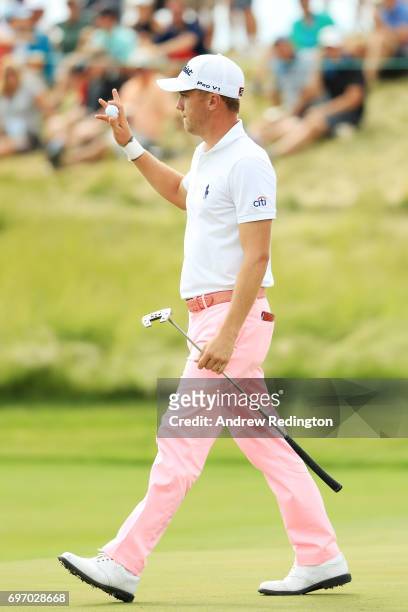 Justin Thomas of the United States reacts after making a birdie on the 17th green during the third round of the 2017 U.S. Open at Erin Hills on June...