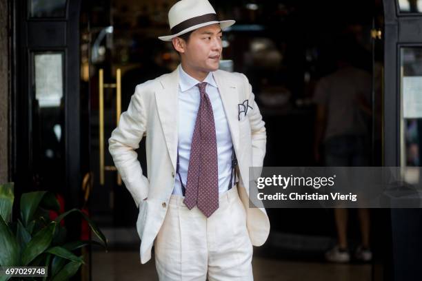 Seongsu Kim wearing a creme suit, straw hat is seen outside Dolce & Gabbana during Milan Men's Fashion Week Spring/Summer 2018 on June 17, 2017 in...