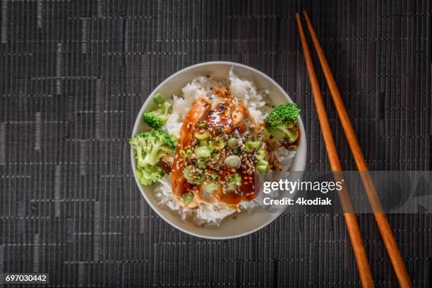 grilled chicken breast with teriyaki sauce over steamed rice - rice bowl stock pictures, royalty-free photos & images