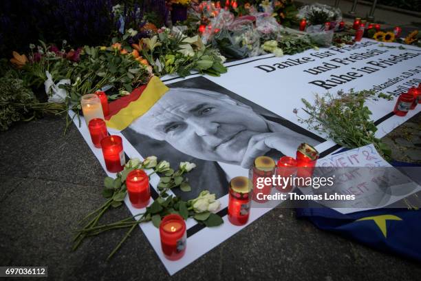 Flowers and Candles lay next to a portrait of Helmut Kohl in front of the home of former German Chancellor Helmut Kohl in Oggersheim district on June...