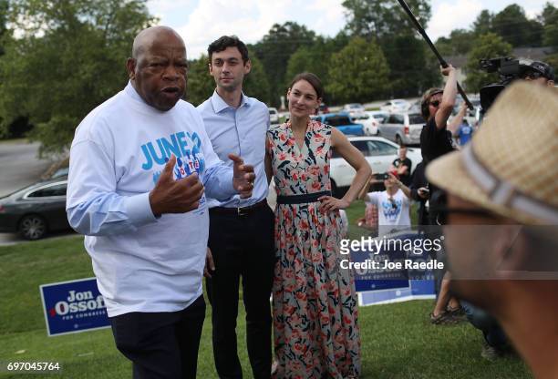 Democratic candidate Jon Ossoff and his girlfriend, Alisha Kramer, listen as Rep. John Lewis endorses him during a meet and greet with voters at a...