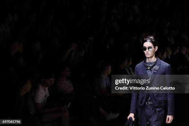 Model walks the runway at the Emporio Armani fashion show during Milan Men's Fashion Week Spring/Summer 2018on June 17, 2017 in Milan, Italy.