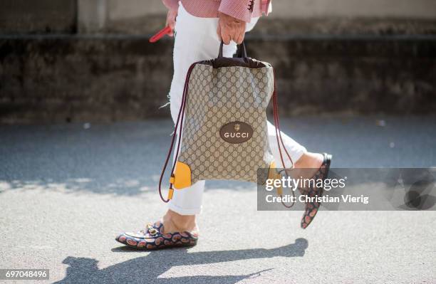 Gucci bag is seen outside Diesel during Milan Men's Fashion Week Spring/Summer 2018 on June 17, 2017 in Milan, Italy.