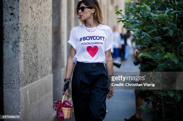 Guest with a tshirt with the print Boycott is seen outside Dolce & Gabbana during Milan Men's Fashion Week Spring/Summer 2018 on June 17, 2017 in...
