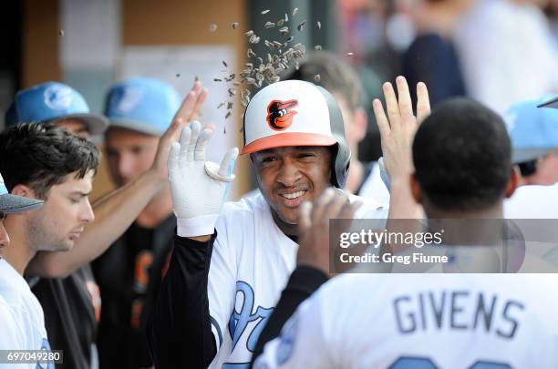 Jonathan Schoop of the Baltimore Orioles celebrates with teammates after hitting a home run in the seventh inning against the St. Louis Cardinals at...