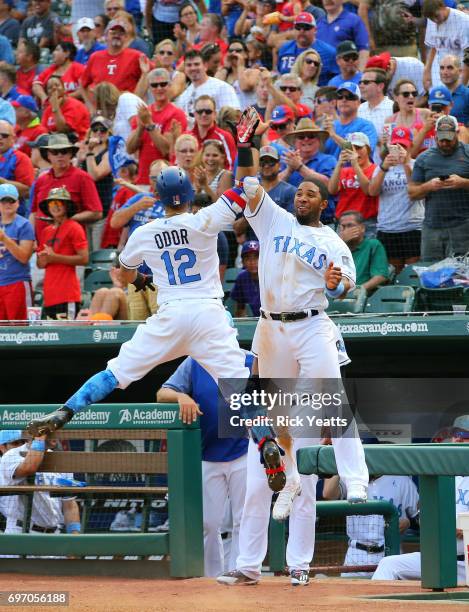 Elvis Andrus of the Texas Rangers congratulates Rougned Odor for hitting a solo home run in the sixth inning against the Seattle Mariners at Globe...