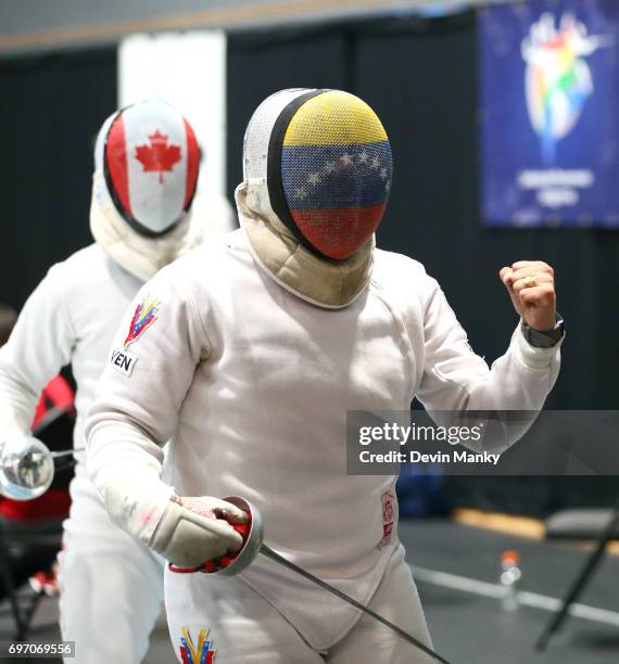 Jesus Limardo of Venezuela celebrates making a touch against Maxime Brinck-Croteau of Canada during semi-final action in the Team Men's Epee event on...