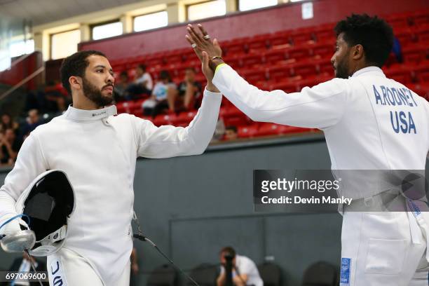 Team USA Teammates Benjamin Bratton and Adam Rodney share a high-five after a bout during the Team Men's Epee event on June 17, 2017 at the...