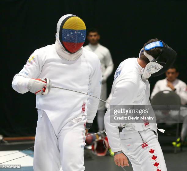 Francisco Limardo of Venezuela makes a touch to the back of Marc-Antoine Blais-Belanger of Canada during semi-final action in the Team Men's Epee...