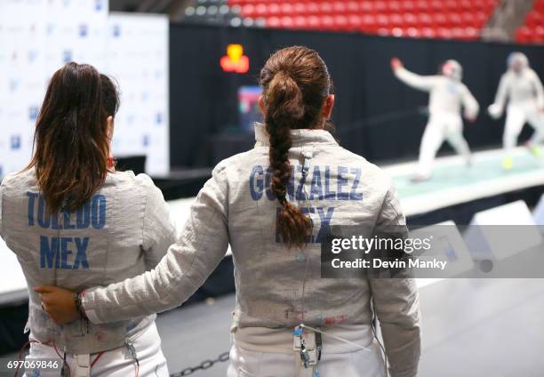 Ursula Gonzalez Garate of Mexico and teammate Julieta Toledo watch a teammate fence during the gold medal match in the Team Women's Sabre event on...