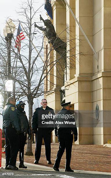 Police officers stand guard outside a federal courthouse February 13, 2002 prior to the third appearance of American Taliban fighter John Walker...