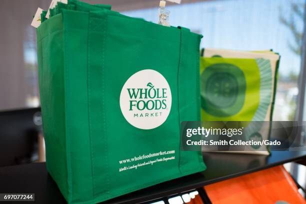 Reusable shopping bag with logo at Whole Foods Market grocery store in Dublin, California, June 16, 2017. On June 16 Amazon.com announced that it...