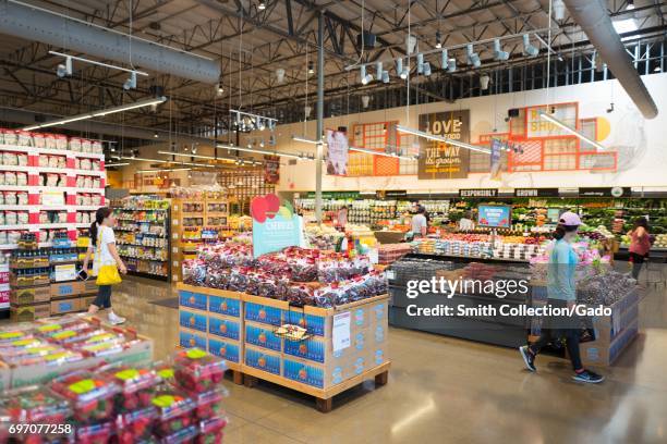 Shoppers browse the produce section at Whole Foods Market grocery store in Dublin, California, June 16 June 16, 2017. On June 16 Amazon.com announced...