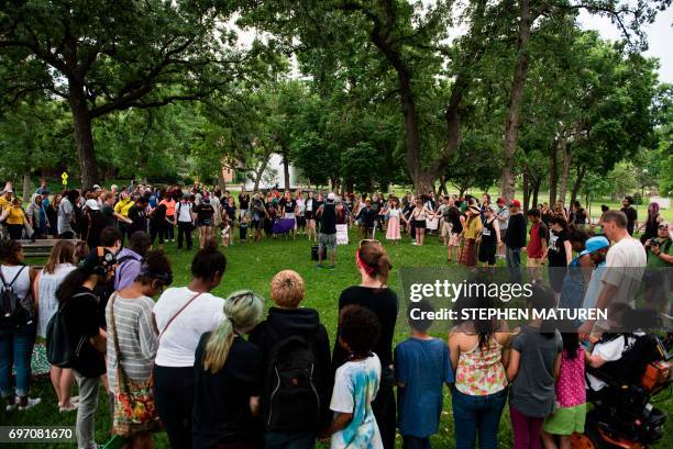 Crowd of demonstrators prays together in Loring Park on July 17, 2017 in Minneapolis, Minnesota. Demonstrations have taken place each day since a...