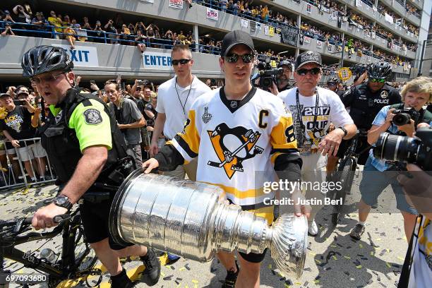 Sidney Crosby of the Pittsburgh Penguins walks with the Stanley Cup during the Victory Parade and Rally on June 14, 2017 in Pittsburgh, Pennsylvania.