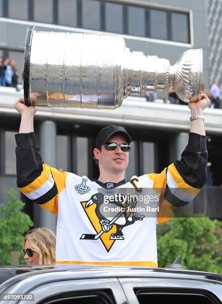 Sidney Crosby of the Pittsburgh Penguins hoists the Stanley Cup during the Victory Parade and Rally on June 14, 2017 in Pittsburgh, Pennsylvania.