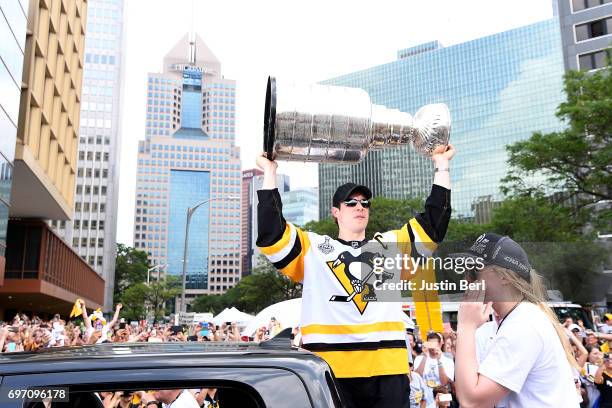 Sidney Crosby of the Pittsburgh Penguins hoists the Stanley Cup during the Victory Parade and Rally on June 14, 2017 in Pittsburgh, Pennsylvania.