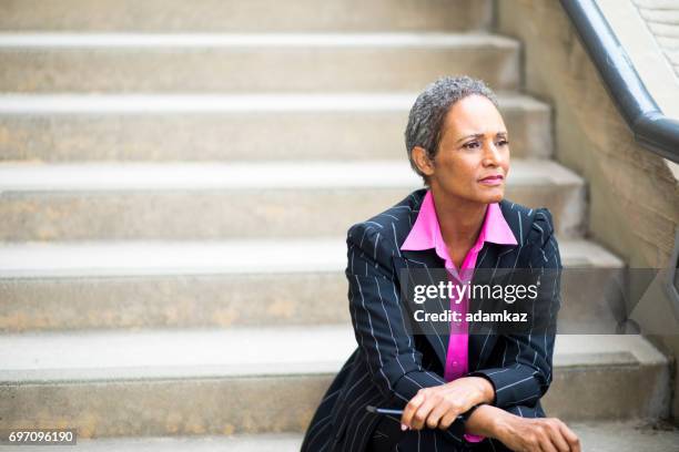 distinguished senior african american businesswoman - pink suit stock pictures, royalty-free photos & images
