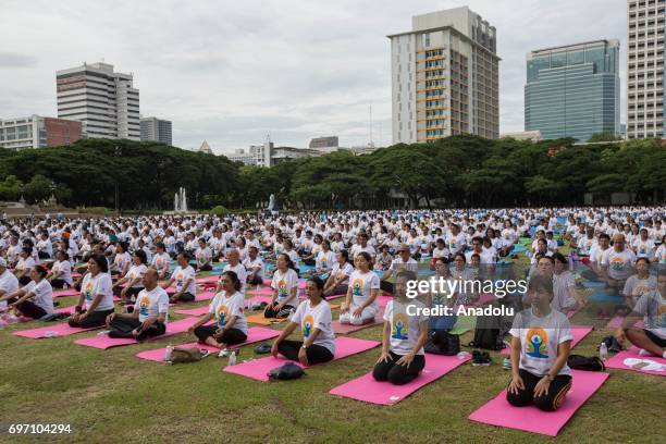 Thousand of Yoga practitioners commemorate the 3rd 'International Yoga Day' held by the Indian Embassy at the Chulalongkorn University in Central...
