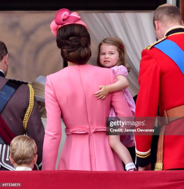 Catherine, Duchess of Cambridge and Princess Charlotte of Cambridge stand on the balcony of Buckingham Palace during the Trooping the Colour parade...