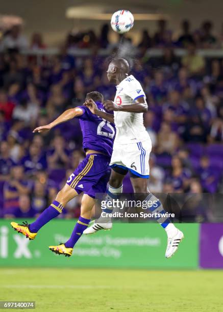 Montreal Impact defender Hassoun Camara and Orlando City SC defender Donny Toia go up for a header During the MLS Soccer match between Orlando City...
