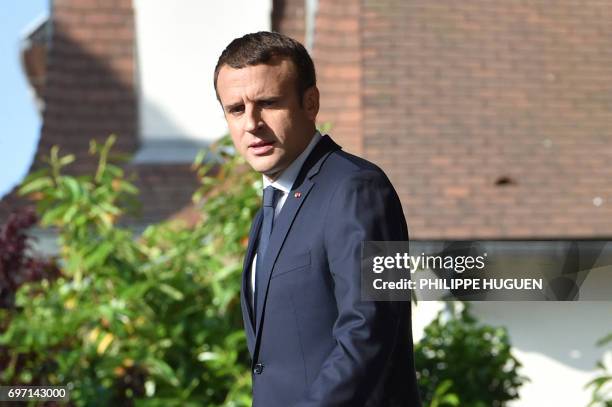 French President Emmanuel Macron leaves his house to vote in Le Touquet, northern France, during the second round of the French parliamentary...