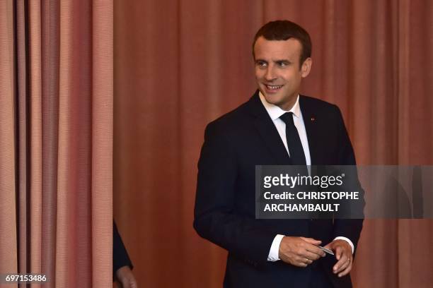 French President Emmanuel Macron arrives to vote at a polling station in Le Touquet, northern France, during the second round of the French...