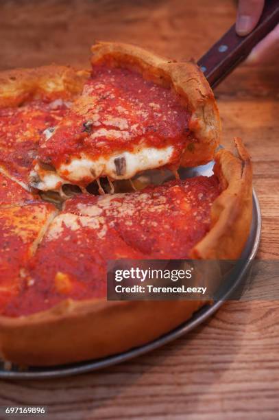 chicago deep dish pizza on table - deep dish pizza stock pictures, royalty-free photos & images