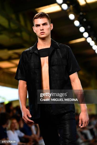 Model presents a creation for fashion house Dirk Bikkembergs during the Men's Spring/Summer 2018 fashion shows in Milan, on June 18, 2017. / AFP...