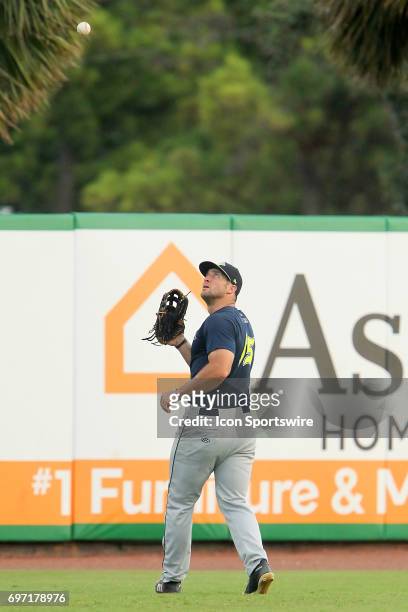 Tim Tebow of the Fireflies sets up to catch a fly ball during the minor league game between the Columbia Fireflies and the Charleston RiverDogs on...
