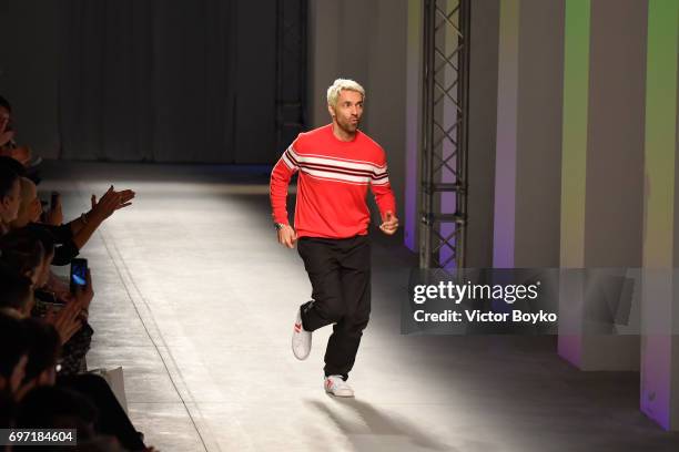 Fashion designer Massimo Giorgetti acknowledges the applause of the audience at the MSGM show during Milan Men's Fashion Week Spring/Summer 2018 on...