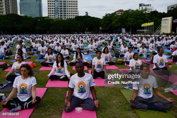 Thousands of people participate in a yoga exercise at Chulalongkorn University field, marking the International Day of Yoga in Bangkok, Thailand....