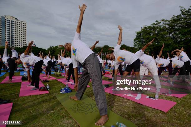 Thousands of people participate in a yoga exercise at Chulalongkorn University field, marking the International Day of Yoga in Bangkok, Thailand....