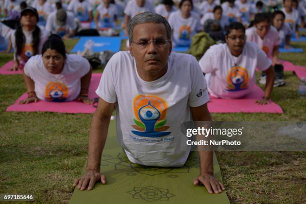 Thousands of people participate in a yoga exercise at Chulalongkorn University field, marking the International Day of Yoga in Bangkok, Thailand....