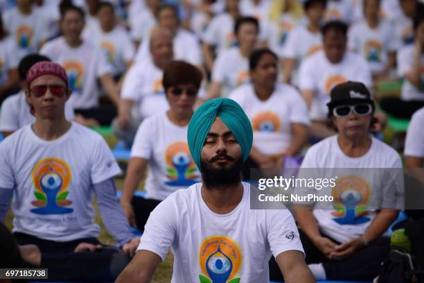 Thousands of people participate in a yoga exercise at Chulalongkorn University field, marking the International Day of Yoga in Bangkok, Thailand....