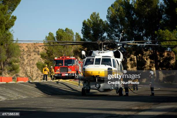 Los Angeles County fire fighting helicopter refilling water at a parking lot during the Castaic Lake fire in Castaic, California on June 17,...