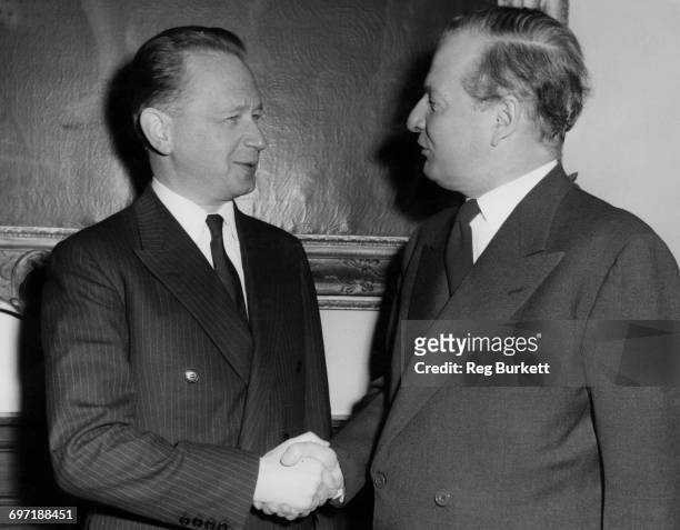 Secretary General Dag Hammarskjöld and British Foreign Secretary Selwyn Lloyd shaking hands prior to a meeting at the Foreign Office, London, 31st...