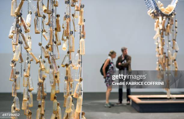 Visitor walk past an artwork entitled "Messages from the Athlantic Passage" by South African artist and writer Sue Williamson at the Unlimited show...