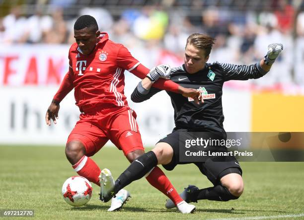 Franck Evina of FC Bayern Muenchen challenges Luca Plogmann of SV Werder Bremen during the B Juniors German Championship Final between FC Bayern...